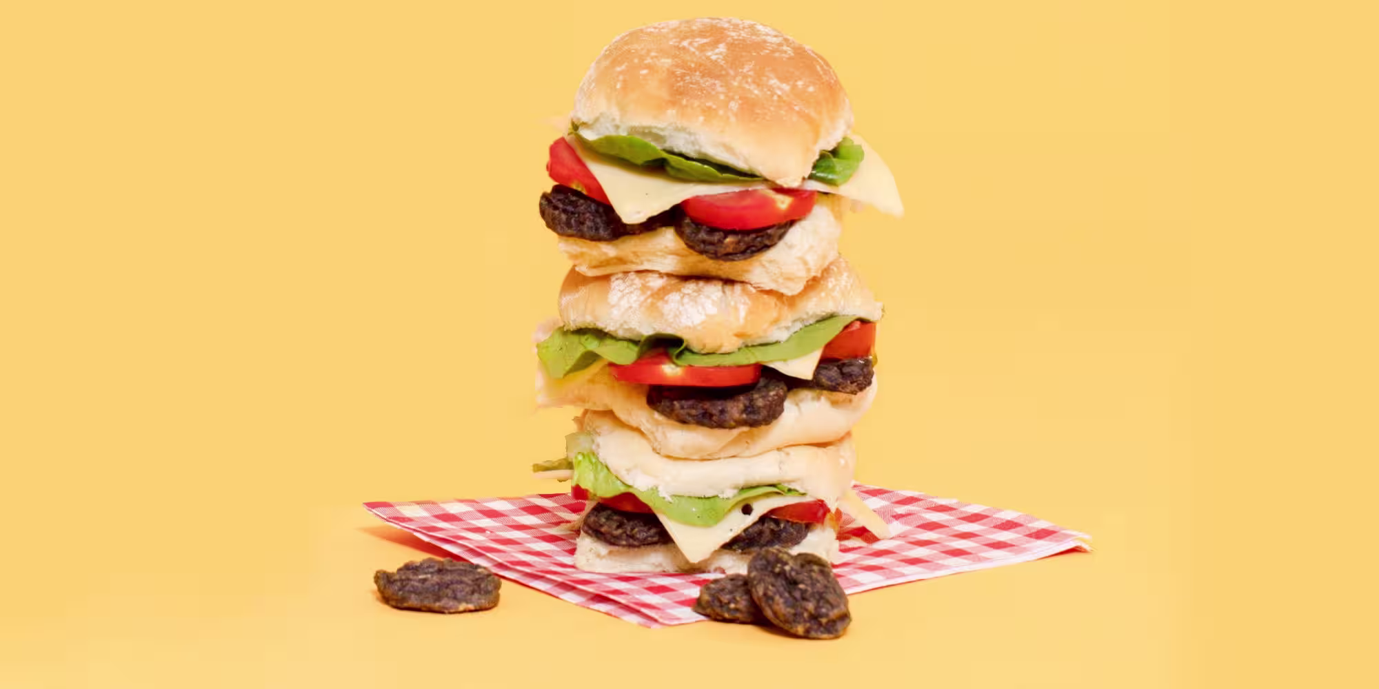 A burger made of Pooch & Mutt Smokin' BBQ Burgers on an orange background